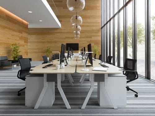 Modern open-plan workspace with warm wood detailing, representing the OC Studios of Tampa Bay approach
