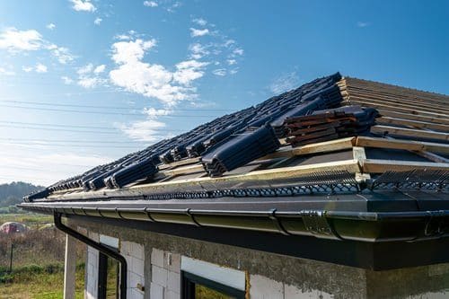 Elevated view of a residential rooftop and surrounding neighbourhood captured by drone