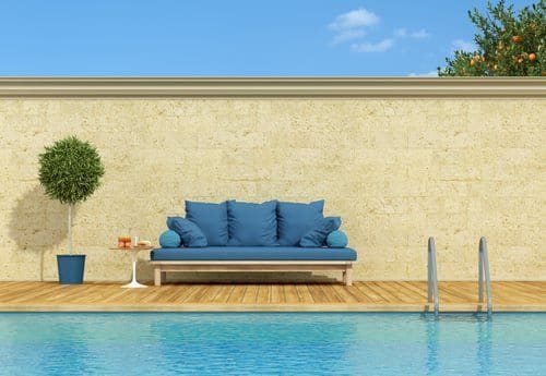 Swimming pool and landscaped surround at dusk, lit for a twilight exterior real estate photograph