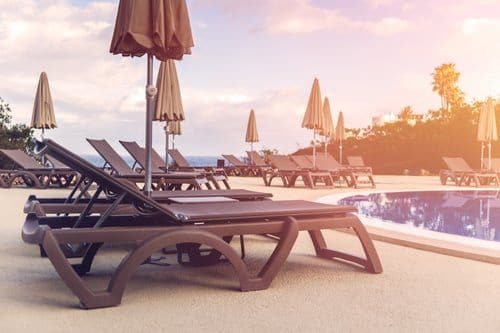 Poolside loungers at dusk, from the OC Studios of Tampa Bay property portfolio